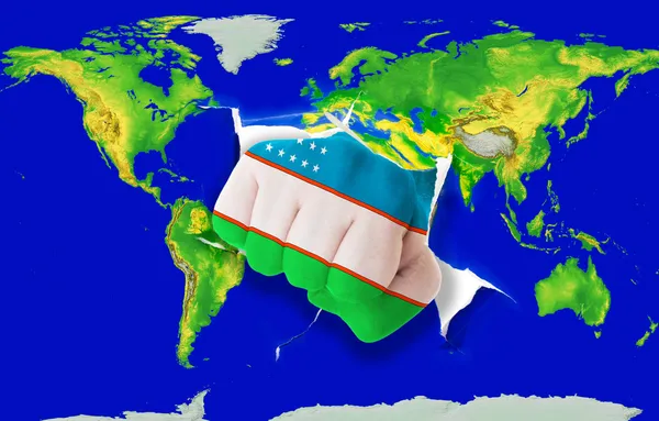 Кулак в кольорі національний прапор Узбекистану, що пробиває карту світу — стокове фото