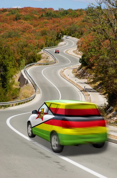 Car on road in national flag of zimbabwe colors — Stock Photo, Image