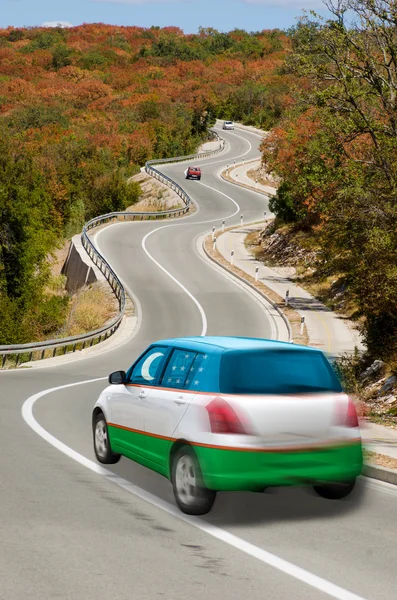 Car on road in national flag of uzbekistan colors — Stock Photo, Image