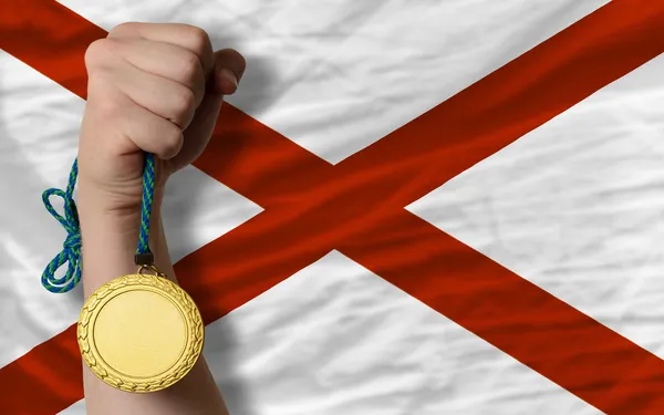 Gold medal for sport and flag of american state of alabama — Stock Photo, Image