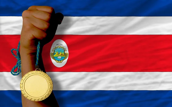 Medalla de oro para el deporte y la bandera nacional de costarica —  Fotos de Stock