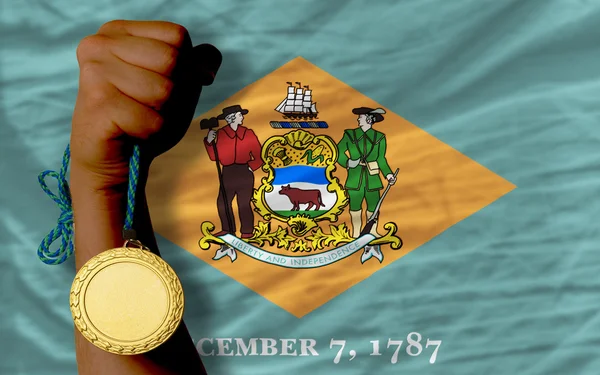 Gold medal for sport and flag of american state of delaware — ストック写真