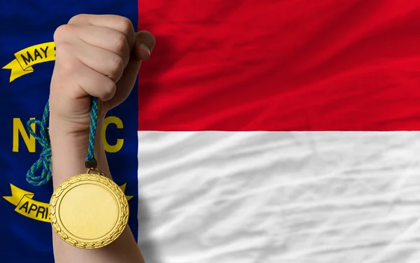 Gold medal for sport and flag of american state of north caroli — Stock Photo, Image