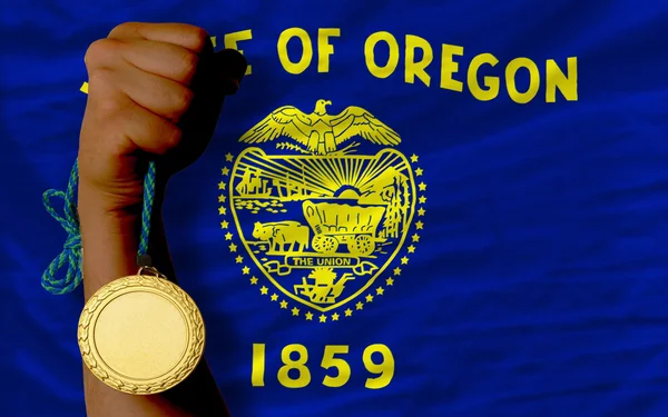 Gold medal for sport and flag of american state of oregon — Stock Photo, Image