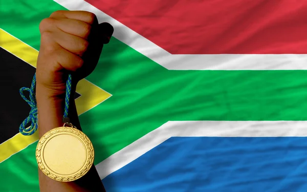 Zlatá medaile pro sport a státní vlajka Jihoafrické republiky — Stock fotografie