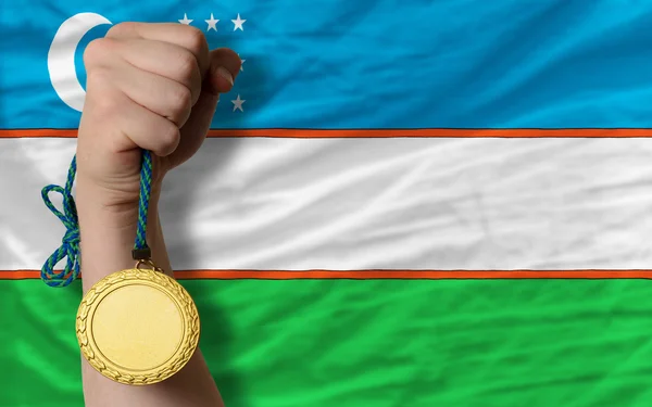 Gold medal for sport and national flag of uzbekistan — Stock Photo, Image