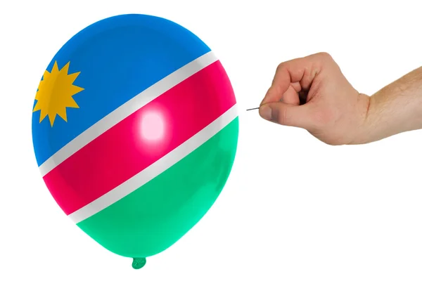 Bursting balloon colored in national flag of namibia — Stock Photo, Image