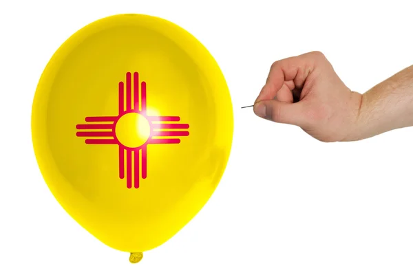 Bursting balloon colored in flag of american state of new mexic — Stock Photo, Image