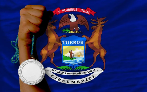 Silver medal for sport and flag of american state of michigan — Stock Photo, Image