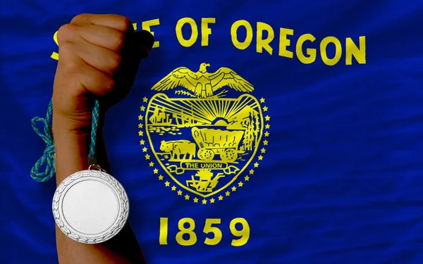 Silver medal for sport and flag of american state of oregon — Stock Photo, Image