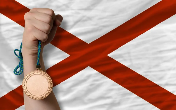 Bronze medal for sport and flag of american state of alabama — Stock Photo, Image