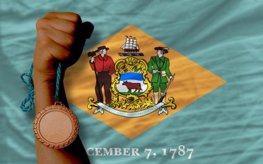 Bronze medal for sport and flag of american state of delaware
