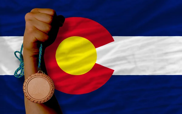 Bronze medal for sport and flag of american state of colorado — Stock Photo, Image