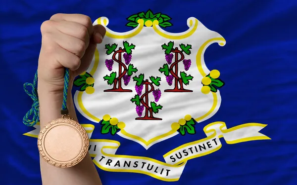 Bronze medal for sport and flag of american state of connecticu — Stock Photo, Image