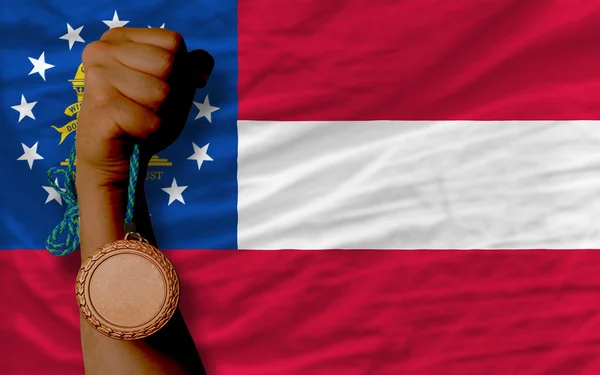 Medaglia di bronzo per lo sport e bandiera dello stato americano della georgia — Foto Stock