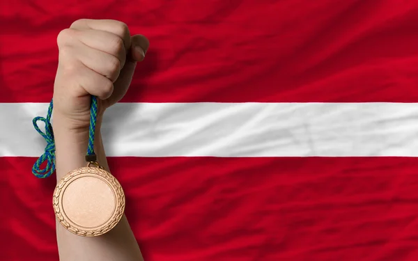 Bronze medal for sport and national flag of latvia — Stock Photo, Image