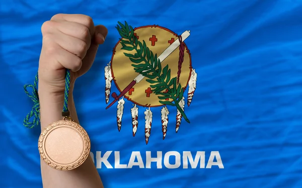Bronze medal for sport and flag of american state of oklahoma — Stock Photo, Image