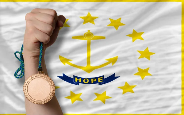 Bronze medal for sport and flag of american state of rhode isla — Stock fotografie