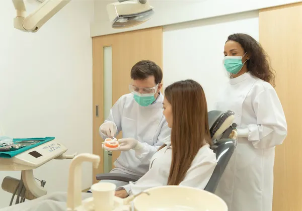 Людині Стоматологу Яка Показує Користуватися Зубною Щіткою Типовими Зубами Азіатського — стокове фото