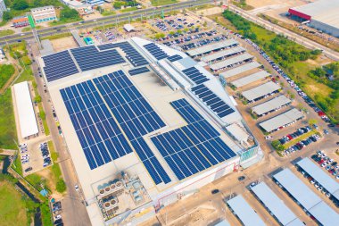 Aerial view of solar panels or solar cells on the roof of shopping mall building rooftop. Power plant, renewable clean energy source. Eco technology for electric power in industry.