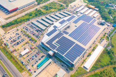 Aerial view of solar panels or solar cells on the roof of shopping mall building rooftop. Power plant, renewable clean energy source. Eco technology for electric power in industry.