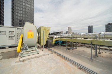 Chiller tower or cooling tower on rooftop of a office building in urban city. System work. Architecture machine. Condenser Water Supply and Condenser Water Return pipe lines. Ventilation compressor.