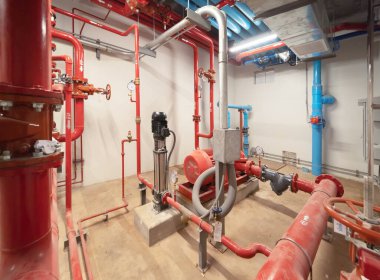 Industry factory. Chiller tower on rooftop building. Fire protection system work machine. Condenser Water Supply pipe lines. Workshop site.