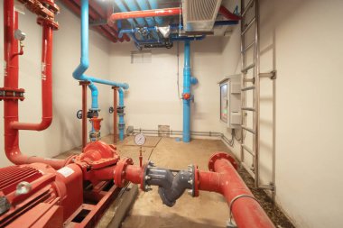 Industry factory. Chiller tower on rooftop building. Fire protection system work machine. Condenser Water Supply pipe lines. Workshop site.