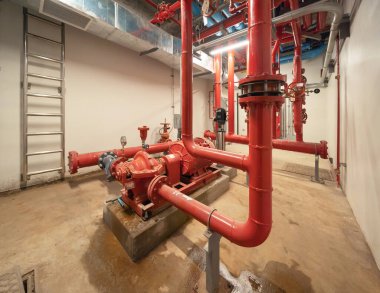 Industry factory. Chiller tower on rooftop building. Fire protection system work machine. Condenser Water Supply pipe lines. Workshop site.