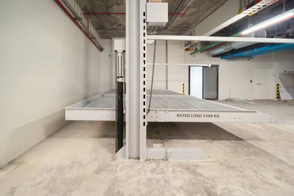 Automatic row of cars of lift or elevator parking system, mechanical vehicle  innovative material and building platforms in transportation service concept. Underconstruction site.