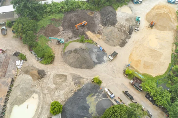 Aerial top view of ground in the land with sand in factory industry for construction site. Arid pattern texture background. Bulldozer tractor