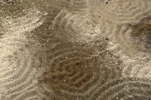 Circles on multitoned brown sand surface — Stock Photo, Image