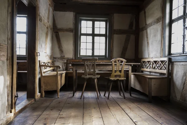 Rustic chamber with bench, table and chair. — Stock Photo, Image