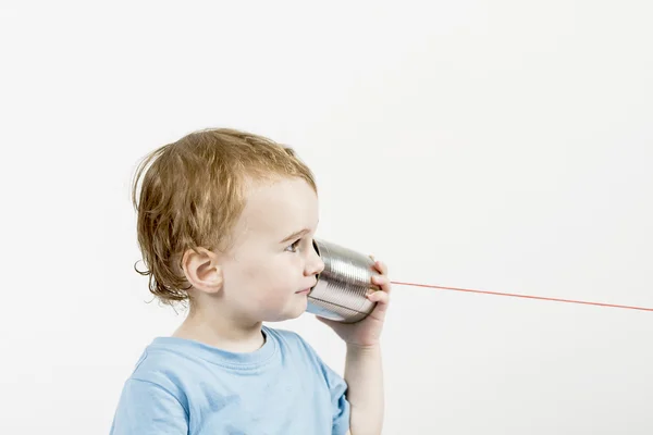 Young child with tin can phone — Stock Photo, Image