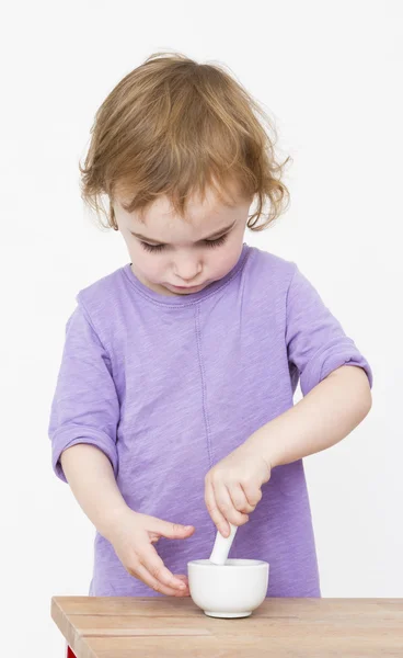 Child working with mortar — Stock Photo, Image