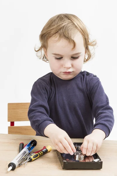 Little girl repairing computer parts — Stock Photo, Image