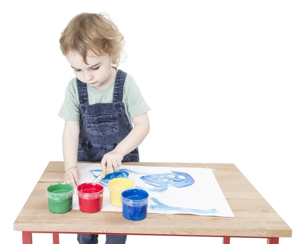 Child making painting on small desk — Stock Photo, Image