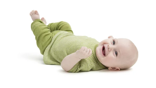 Happy toddler lying on his back Stock Image