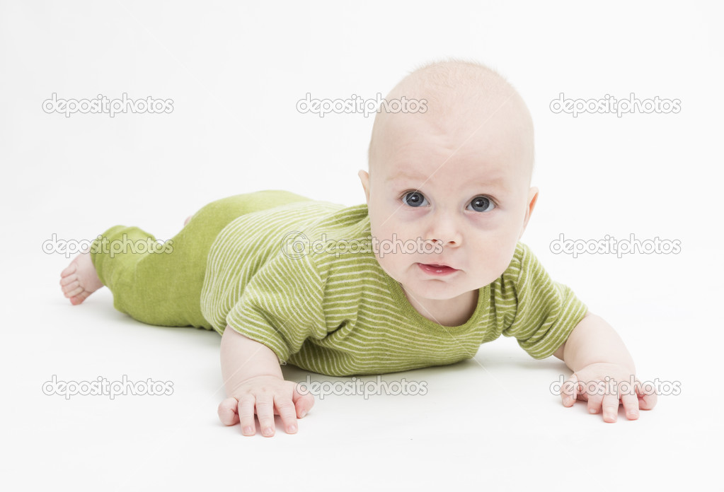 curious toddler in green clothing