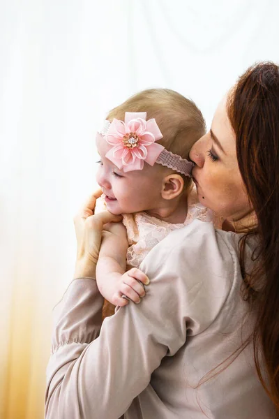 Mother is hugging her little daughter. Maternal hugs. Concept of mother care.