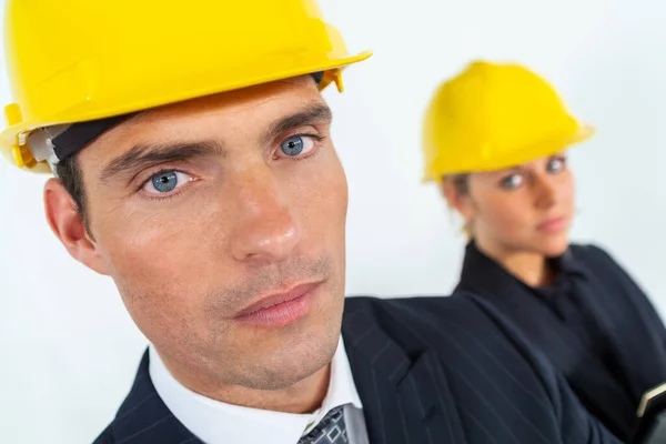 Male Female Construction Workers Builders Wearing Yellow Hard Hats Looking Stock Image