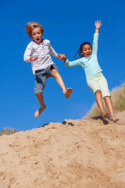 Two Children African American Biracial Girl Blonde Boy Playing Jumping — Stok fotoğraf