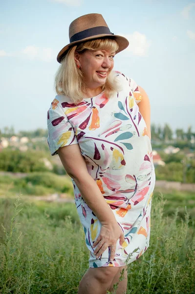 Además de mujer joven de tamaño en vestido con sombrero en la naturaleza en el parque durante el verano. Vida de la gente xl tamaño, feliz mujer belleza natural agradable. Concepto de sobrepeso, viajar —  Fotos de Stock