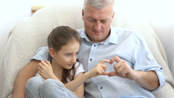 Mature handsome man and little blonde girl are showing hearts by hands, happy family, togetherness, fathers day concepts — Stock Video