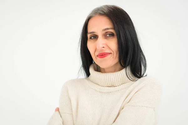 Middle aged woman starting getting grey-haired is posing in studio in sweater on white background, face skin care beauty, middle age skincare cosmetics, cosmetology concept — Stock Photo, Image