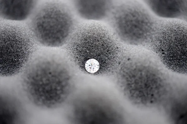 Single Diamond on sponge / rock surface — стоковое фото