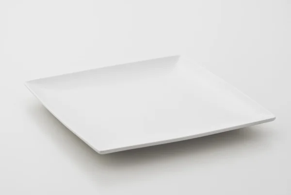 Porcelain plate on white background — Stock Photo, Image