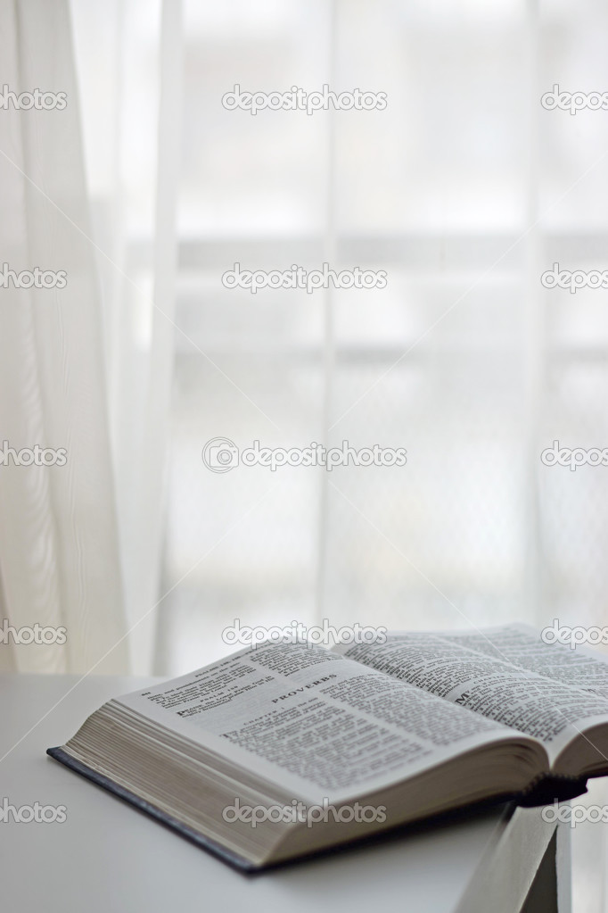 Open Bible next to the window
