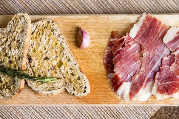 Spanish ham with toasts — Stock Photo, Image
