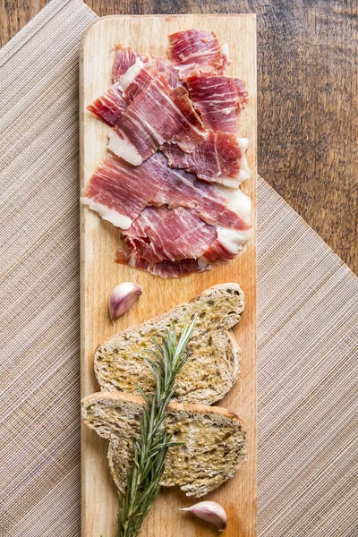 Spanish ham with toasts, top view — Stock Photo, Image